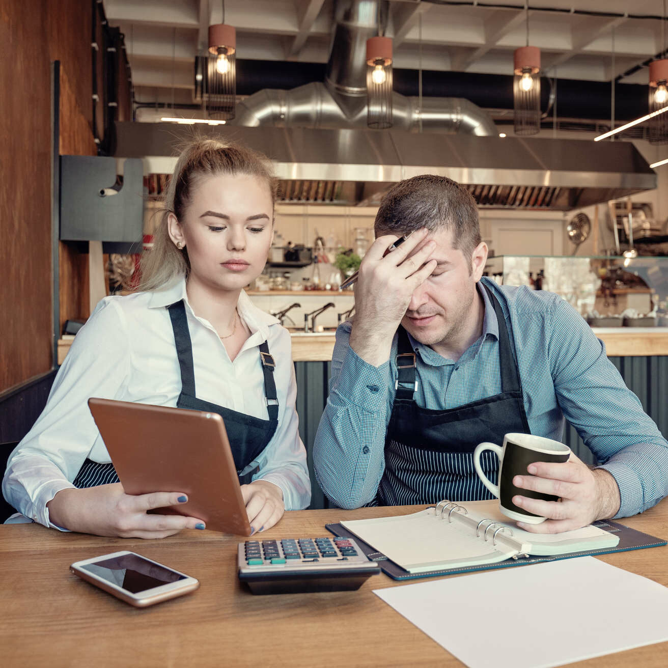 Nervous manager checking restaurant finance - Failure in small-business concept. Depressed male and female entrepreneurs overwhelmed by finance problems